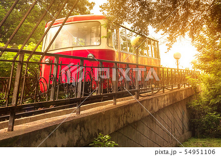 The Red Car of the Funicular rises in the bright sunlight of an evening sunset in the capital of the The Red Car of the Funicular rises in the bright sunlight of an evening sunset in the capital of the 54951106