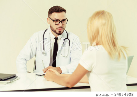 Male Doctor and Female Patient in Hospital Office Male Doctor and Female Patient in Hospital Office 54954908