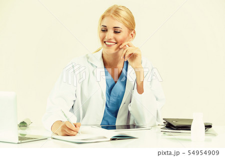 Doctor in hospital working on medical report. Doctor in hospital working on medical report. 54954909