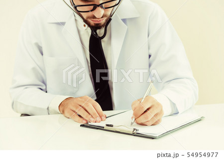 Doctor in hospital writing on a paper document. Doctor in hospital writing on a paper document. 54954977