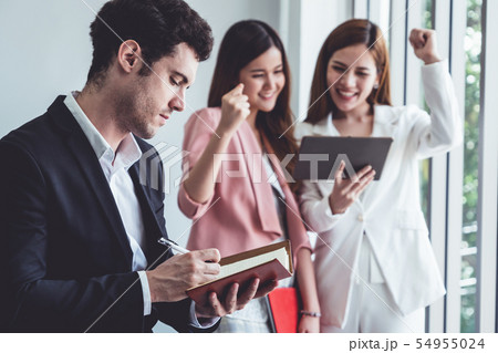 Businessman reading book in business office . 54955024