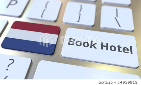 BOOK HOTEL text and flag of the Netherlands on the buttons on the computer keyboard. Travel related 54959918