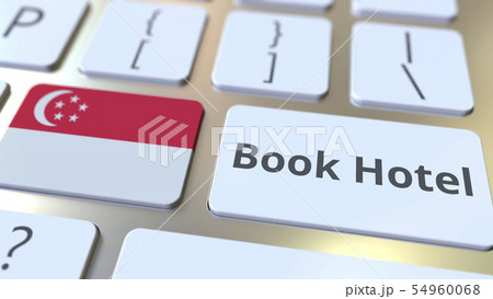 BOOK HOTEL text and flag of Singapore on the buttons on the computer keyboard. Travel related 54960068