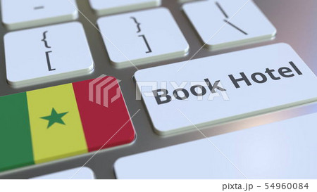 BOOK HOTEL text and flag of Senegal on the buttons on the computer keyboard. Travel related BOOK HOTEL text and flag of Senegal on the buttons on the computer keyboard. Travel related 54960084