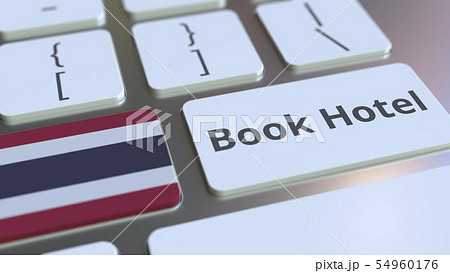 BOOK HOTEL text and flag of Thailand on the buttons on the computer keyboard. Travel related 54960176