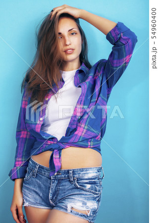 young pretty girl posing happy smiling on blue background, lifestyle people on summer vacation 54960400