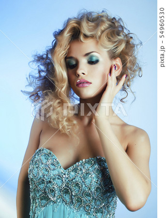young pretty blond woman with hight curly hairstyle posing stylish in blue dress closeup young pretty blond woman with hight curly hairstyle posing stylish in blue dress closeup 54960530