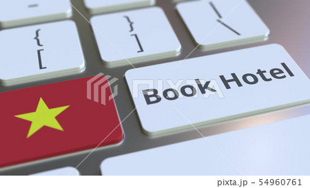 BOOK HOTEL text and flag of Vietnam on the buttons on the computer keyboard. Travel related BOOK HOTEL text and flag of Vietnam on the buttons on the computer keyboard. Travel related 54960761