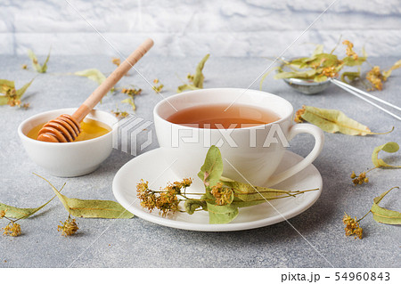 Cup of green tea and flowers linden on grey  54960843