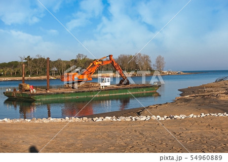 Excavator for channel dredge on a barge. 54960889