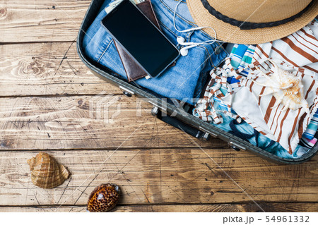 Travel preparations concept with suitcase, clothes Travel preparations concept with suitcase, clothes 54961332