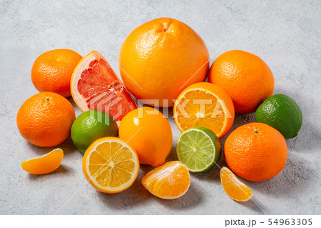 group of whole and sliced citrus fruits - tangerines, lemons, limes, oranges, grapefruits on the 54963305