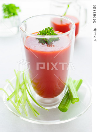 a glass of organic tomato juice, parsley, celery a glass of organic tomato juice, parsley, celery 54965386