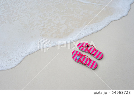 Flip flops on the beach. Flip flops on the beach. 54968728