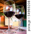 Glass of red wine on a table in rustic restaurant. 54969208