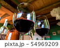 Glass of red wine on a table in rustic restaurant. 54969209