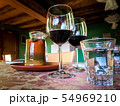 Glass of red wine on a table in rustic restaurant. 54969210