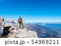 Hiker on the top in mountains. Travel sport 54969211