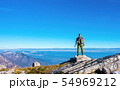 Hiker on the top in mountains. Travel sport 54969212