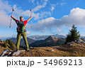 Hiker cheering elated and blissful with arms 54969213