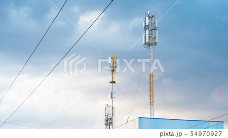 Cellular phone antennas on a building roof. Cellular phone antennas on a building roof. 54970927