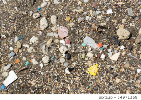 Micro-plastics pollution washed up on sandy beach 54971369
