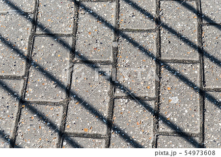 Diagonal shadows on the pavement Diagonal shadows on the pavement 54973608