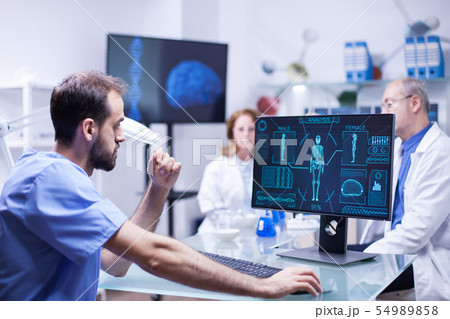 Portrait of young scientist looking at monitor computer checking male body 54989858