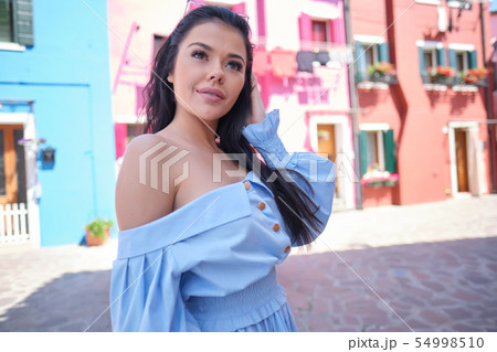 tourist woman posing among colorful houses on 54998510