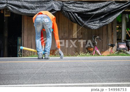 Worker wearing uniform is striping with measuring 54998753