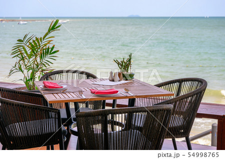 Wooden dining table with tableware and weave 54998765