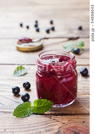 Jar of homemade blueberry jam on a wooden Jar of homemade blueberry jam on a wooden 54999043
