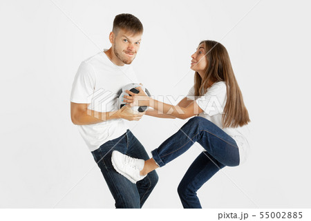Portrait of beautiful couple football fans on white studio background Portrait of beautiful couple football fans on white studio background 55002885