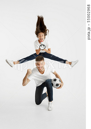 Portrait of beautiful couple football fans on white studio background Portrait of beautiful couple football fans on white studio background 55002968
