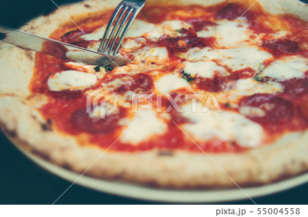 High angle shot of unrecognizable people's hand grabbing a slice of pizza 55004558