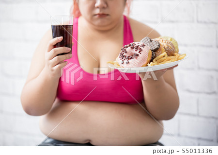 plus size girl with dessert 55011336