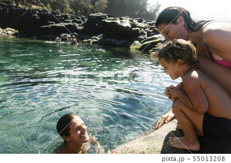 Boy with his parents by tide pool 55013208
