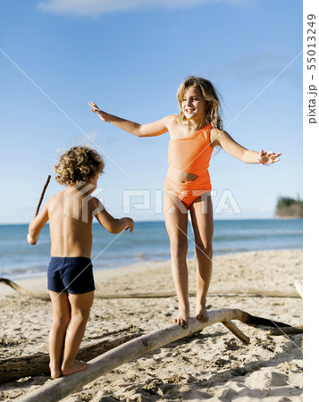 Children balancing on driftwood Children balancing on driftwood 55013249