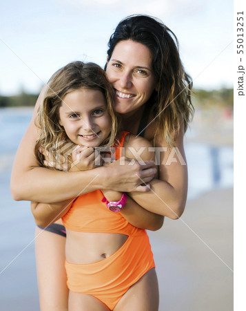 Woman with her daughter on beach 55013251