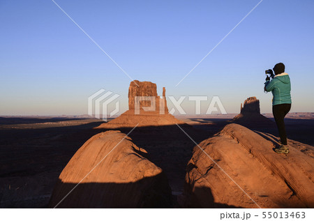 Woman photographing butte in Monument Valley, Arizona, USA Woman photographing butte in Monument Valley, Arizona, USA 55013463
