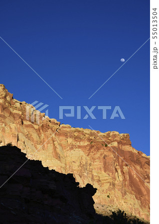 Moon over cliff in shadow in Capitol Reef National Park, USA 55013504