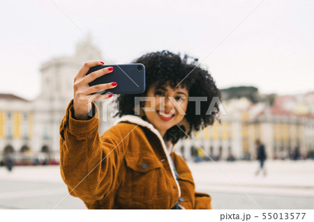 Young woman taking selfie in Lisbon, Portugal 55013577