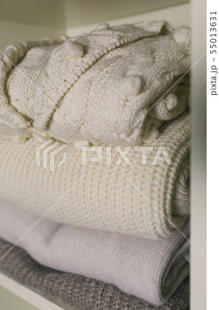 Stack of folded sweaters 55013631