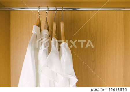 Shirts on clothes hangers in wardrobe Shirts on clothes hangers in wardrobe 55013656