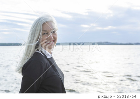 Smiling mature woman by Potomac River in Washington DC, USA Smiling mature woman by Potomac River in Washington DC, USA 55013754