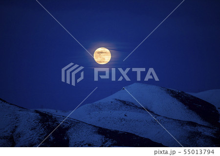 Full moon over mountains at night in Bellevue, Idaho, USA Full moon over mountains at night in Bellevue, Idaho, USA 55013794