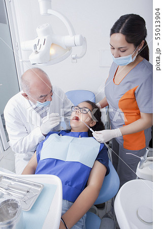 Teenage girl getting dental cleaning Teenage girl getting dental cleaning 55013904