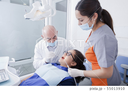 Teenage girl getting dental cleaning Teenage girl getting dental cleaning 55013910