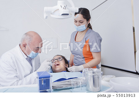 Teenage girl getting dental cleaning Teenage girl getting dental cleaning 55013913