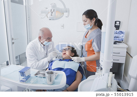 Teenage girl getting dental cleaning 55013915